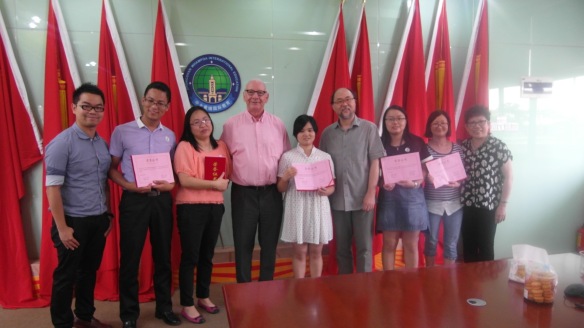 Graham and Dr Wei present certificates to teachers